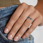Trendy gemstone ring with baguette cut stones and modern geometric band design