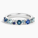 Trendy gemstone ring with baguette cut stones and modern geometric band design