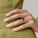 Elegant gemstone ring with blue color stone and shining white stones for luxury style