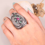 Vintage ruby and emerald cocktail ring in antique style silver setting.