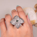 Vintage 4 Petal Pave wedding ring with emerald accents in an Art Deco sterling silver setting.