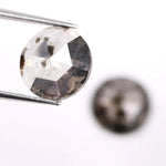 Pair of round rose cut lab grown salt and pepper diamonds with smoky gray tone and natural black inclusions, flat back faceting, matching loose stones for custom engagement rings or jewelry design.