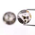 Pair of round rose cut lab grown salt and pepper diamonds with smoky gray tone and natural black inclusions, flat back faceting, matching loose stones for custom engagement rings or jewelry design.