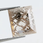 Emerald cut lab grown diamond featuring dramatic salt and pepper style inclusions with natural branching patterns, clear faceting and a unique galaxy-like internal structure.
