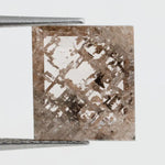 Emerald cut lab grown diamond featuring dramatic salt and pepper style inclusions with natural branching patterns, clear faceting and a unique galaxy-like internal structure.