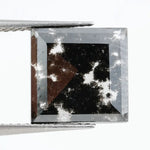 Square cut lab grown diamond with dramatic black and white salt and pepper galaxy inclusions in a geometric cut, showcasing a unique natural-looking pattern ideal for custom engagement rings or statement jewelry.