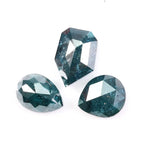 Three natural teal blue diamonds featuring pear, oval, and shield cuts with visible galaxy-like inclusions, rare salt and pepper natural diamonds ideal for custom jewelry design
