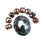 Large natural green diamond surrounded by fancy cognac brown natural diamonds arranged in a semicircle, showcasing rare earth-mined colored diamonds with visible natural inclusions and unique faceting.