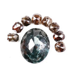 Large natural green diamond surrounded by fancy cognac brown natural diamonds arranged in a semicircle, showcasing rare earth-mined colored diamonds with visible natural inclusions and unique faceting.