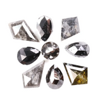 Natural salt and pepper diamonds in mixed geometric shapes including pear, kite, oval and round cuts with gray and black galaxy inclusions, loose natural diamonds for custom engagement rings and artisan jewelry design.