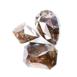 Three natural brown diamonds with unique cuts and facets, showcasing a rich, earthy hue and natural inclusions, perfect for fine jewelry or collectors.