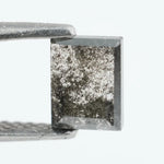 Baguette cut salt and pepper lab grown diamond with natural black inclusions, unique speckled pattern, transparent edges, ethically grown conflict free gemstone for modern jewelry