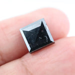 Close-up of a princess cut lab-grown diamond with square shape, sharp facets, and visible inclusions, showcasing modern geometric brilliance and ethical gemstone craftsmanship for jewelry making