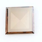 Square pyramid cut lab grown diamond with soft champagne tone, high clarity, polished facets, and modern geometric shape on a clean white background