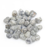 grey white natural diamond with a rugged unpolished surface for jewelry making