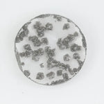 Round faceted lab grown diamond with distinctive black inclusions creating a salt and pepper effect inside a clear polished gemstone