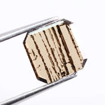 0.88 Ct brown Emerald cut lab grown diamond loose stone with geometric shape and rich brown color sparkle.