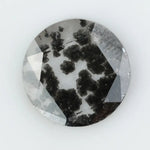Round cut lab grown salt and pepper diamond featuring bold black dendritic inclusions in a transparent stone, faceted for brilliance and showcasing a unique natural pattern