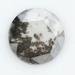 Round faceted lab grown diamond with distinctive salt and pepper style inclusions creating a galaxy-like pattern, showcasing a unique and modern alternative to traditional clear diamonds