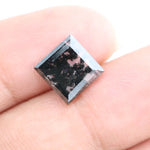 Square cut lab grown diamond with step facets, high clarity, mirror-like reflections, and visible inclusions on a neutral background