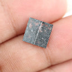 Square cut lab grown diamond with step facets, high clarity, mirror-like reflections, and visible inclusions on a neutral background