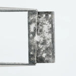 Rectangular step cut lab grown diamond featuring bold black salt and pepper inclusions with mirror-like facets and a modern geometric shape