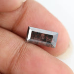 Rectangular step cut lab grown diamond featuring bold black salt and pepper inclusions with mirror-like facets and a modern geometric shape