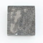 Rectangular step cut salt and pepper lab grown diamond with black galaxy inclusions and scattered white speckles, unique ethical diamond for custom jewelry design