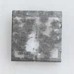 Geometric step cut lab grown salt and pepper diamond with black moss-like inclusions, clear edges and modern faceting, unique ethical loose diamond for alternative engagement ring