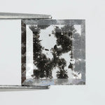 Geometric step cut lab grown salt and pepper diamond with black moss-like inclusions, clear edges and modern faceting, unique ethical loose diamond for alternative engagement ring