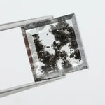 Geometric step cut lab grown salt and pepper diamond with black moss-like inclusions, clear edges and modern faceting, unique ethical loose diamond for alternative engagement ring