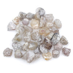 assorted uncut natural diamonds in varied colors for bespoke engagement ring settings and jewelry designs