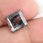 Geometric step cut lab grown salt and pepper diamond with black moss-like inclusions, clear edges and modern faceting, unique ethical loose diamond for alternative engagement ring