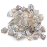 assorted uncut natural diamonds in varied colors for bespoke engagement ring settings and jewelry designs