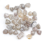 assorted uncut natural diamonds in varied colors for bespoke engagement ring settings and jewelry designs