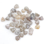 assorted uncut natural diamonds in varied colors for bespoke engagement ring settings and jewelry designs