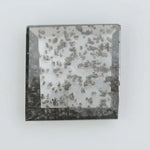 Square step-cut lab grown diamond with dramatic black salt and pepper inclusions, showcasing a unique geometric faceted structure and modern ethical gemstone design