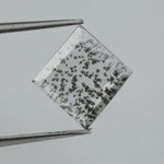 Square step-cut lab grown diamond with dramatic black salt and pepper inclusions, showcasing a unique geometric faceted structure and modern ethical gemstone design