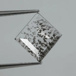 Square step-cut lab grown diamond with dramatic black salt and pepper inclusions, showcasing a unique geometric faceted structure and modern ethical gemstone design