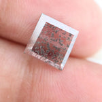 Square step-cut lab grown diamond with dramatic black salt and pepper inclusions, showcasing a unique geometric faceted structure and modern ethical gemstone design