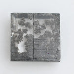 Close-up of a lab-grown diamond featuring unique black inclusions, showcasing exceptional clarity and brilliance, perfect for an elegant jewelry piece.