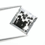 Close-up of a lab-grown diamond featuring unique black inclusions, showcasing exceptional clarity and brilliance, perfect for an elegant jewelry piece.
