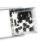 Close-up of a lab-grown diamond featuring unique black inclusions, showcasing exceptional clarity and brilliance, perfect for an elegant jewelry piece.