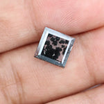 Close-up of a lab-grown diamond featuring unique black inclusions, showcasing exceptional clarity and brilliance, perfect for an elegant jewelry piece.