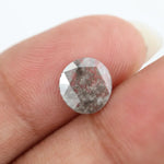 Round lab-grown diamond with unique gray inclusions, faceted for maximum sparkle, ethically created, ideal for custom rings and jewelry