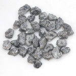 black raw diamond with a natural uncut rough surface for jewelry design projects