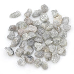 light grey raw diamond with an uncut rough profile for jewelry creation