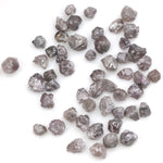 fancy pink raw diamond showing a natural rough surface for gold jewelry design