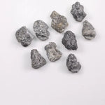 Close-up view of a sparkling gray diamond in a white gold setting.