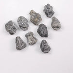 Close-up view of a sparkling gray diamond in a white gold setting.